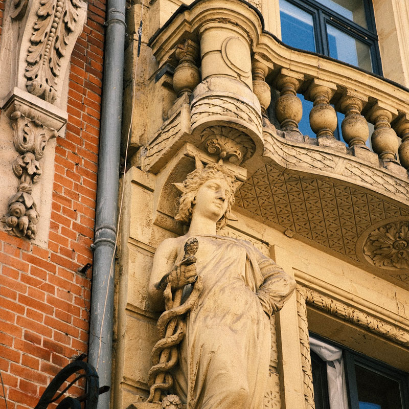 Caryatid sculpture on a historic building in Lille, showcasing the city's rich French heritage during your language immersion